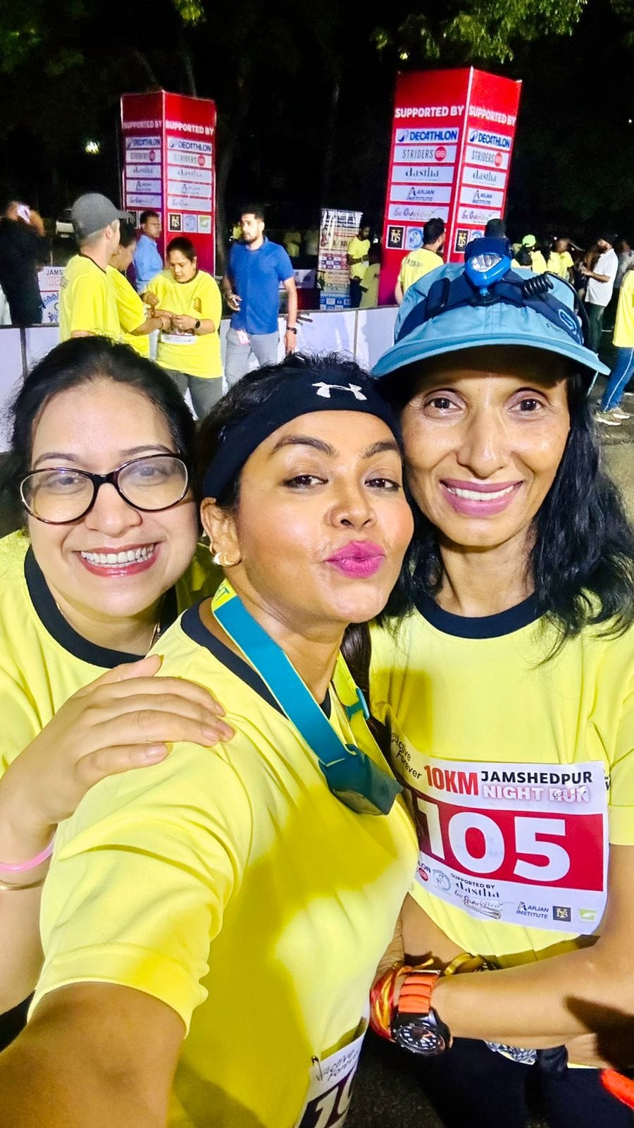 Outdoor fitness boot camp event with trainers leading group exercises, participants in colorful athletic wear, energetic atmosphere with fitness equipment