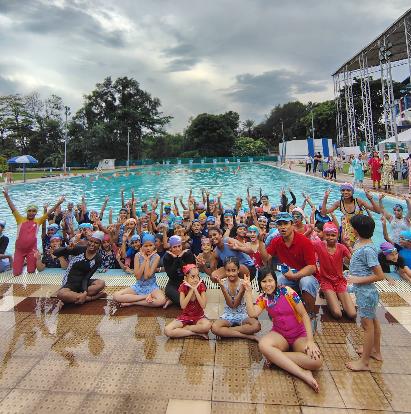 Fitness boot camp with obstacle course, trainers motivating participants, outdoor setting with professional equipment, dynamic group exercise