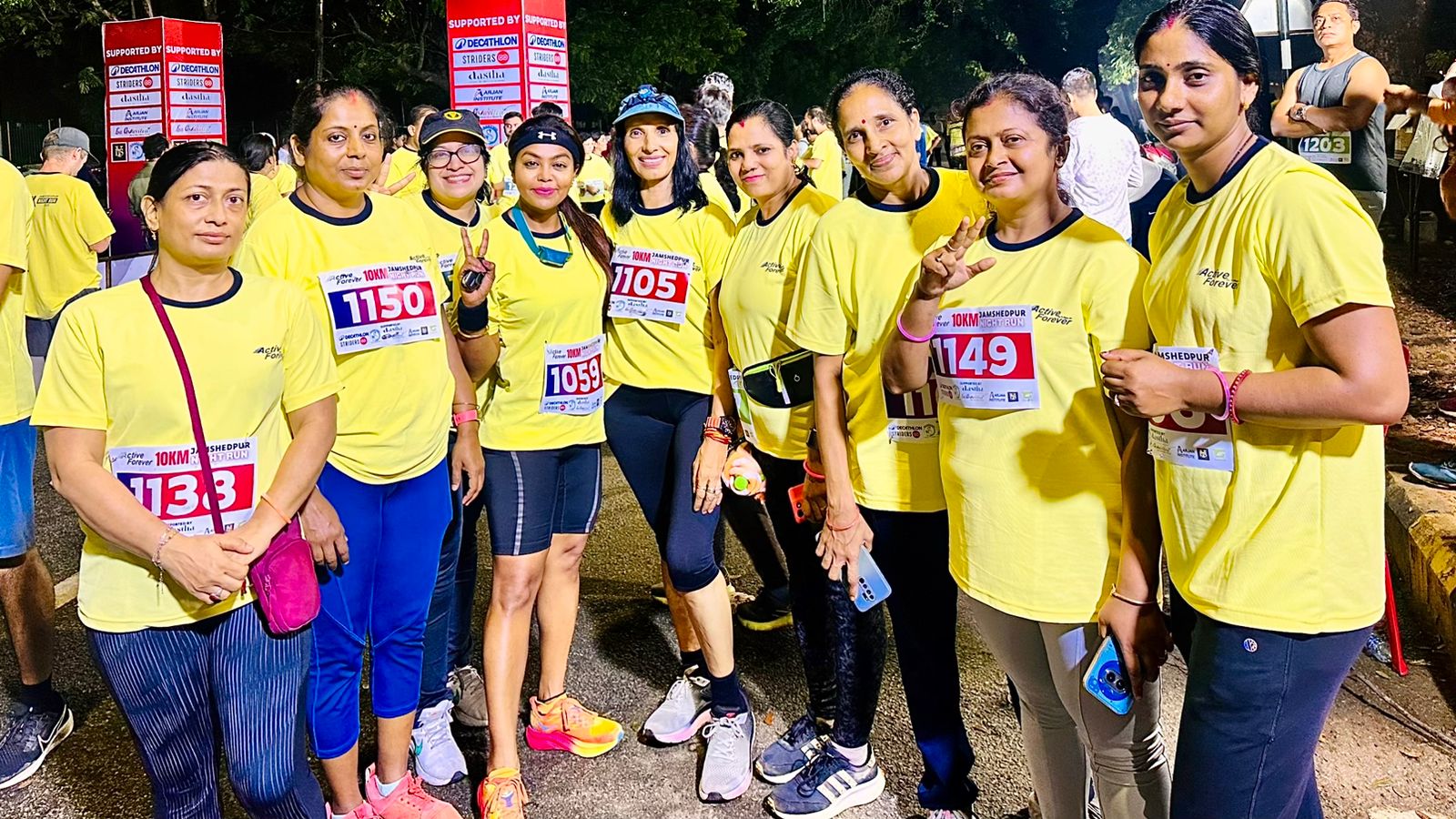 Fitness boot camp with obstacle course, trainers motivating participants, outdoor setting with professional equipment, dynamic group exercise